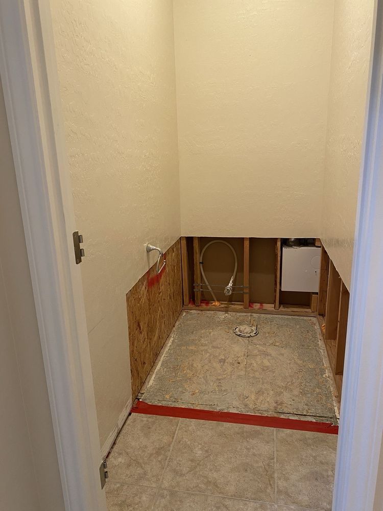 A bathroom under construction with a hole in the wall.