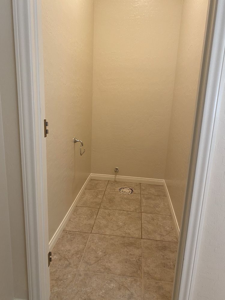 A bathroom with tile floors and white walls is being remodeled.
