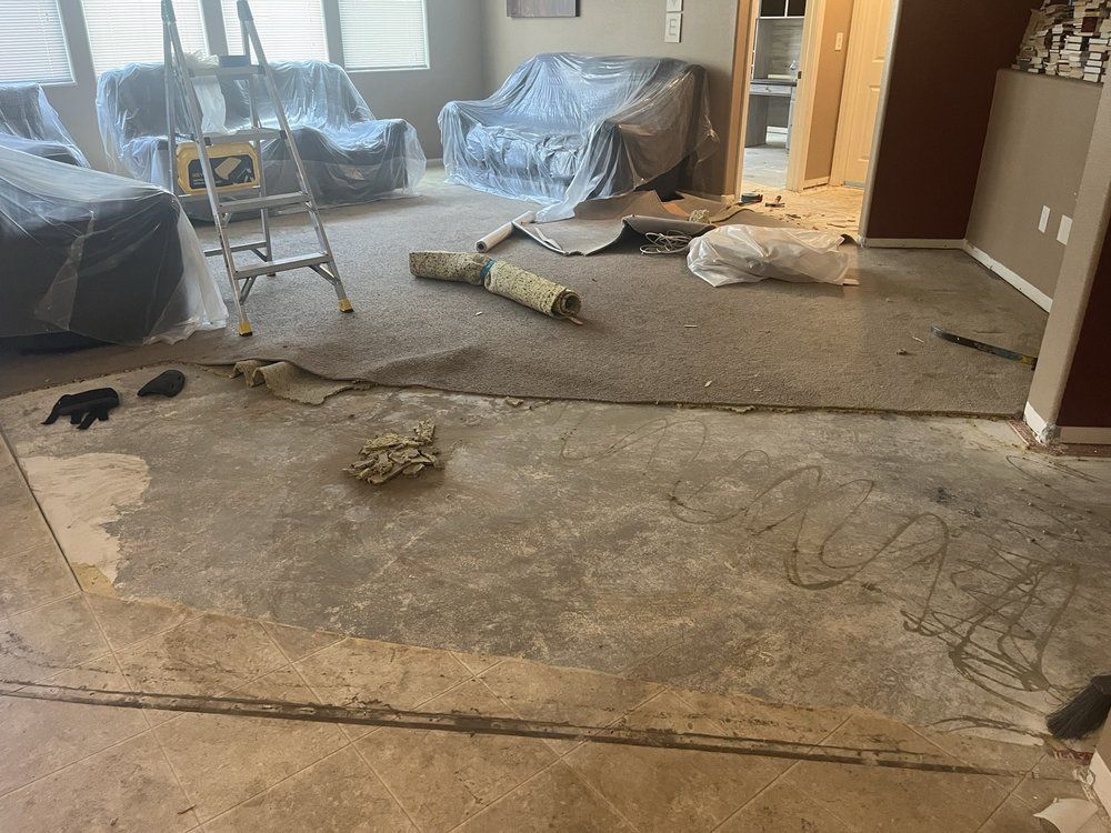 A living room with a couch and a ladder in it.