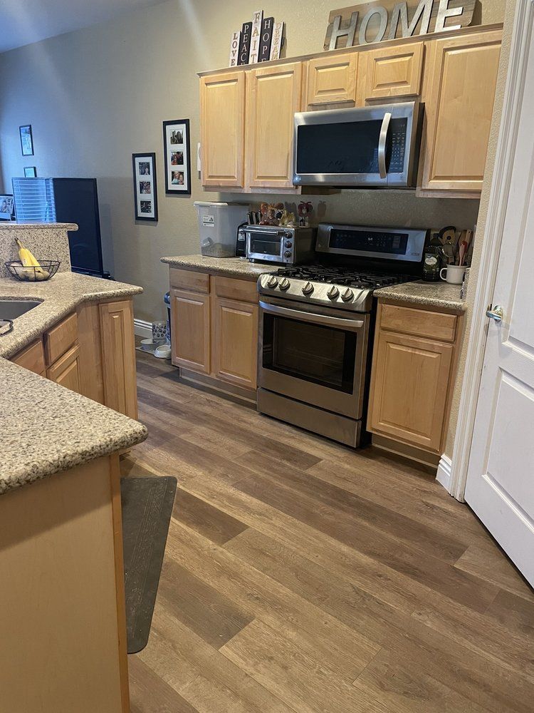 A kitchen with stainless steel appliances and wooden cabinets