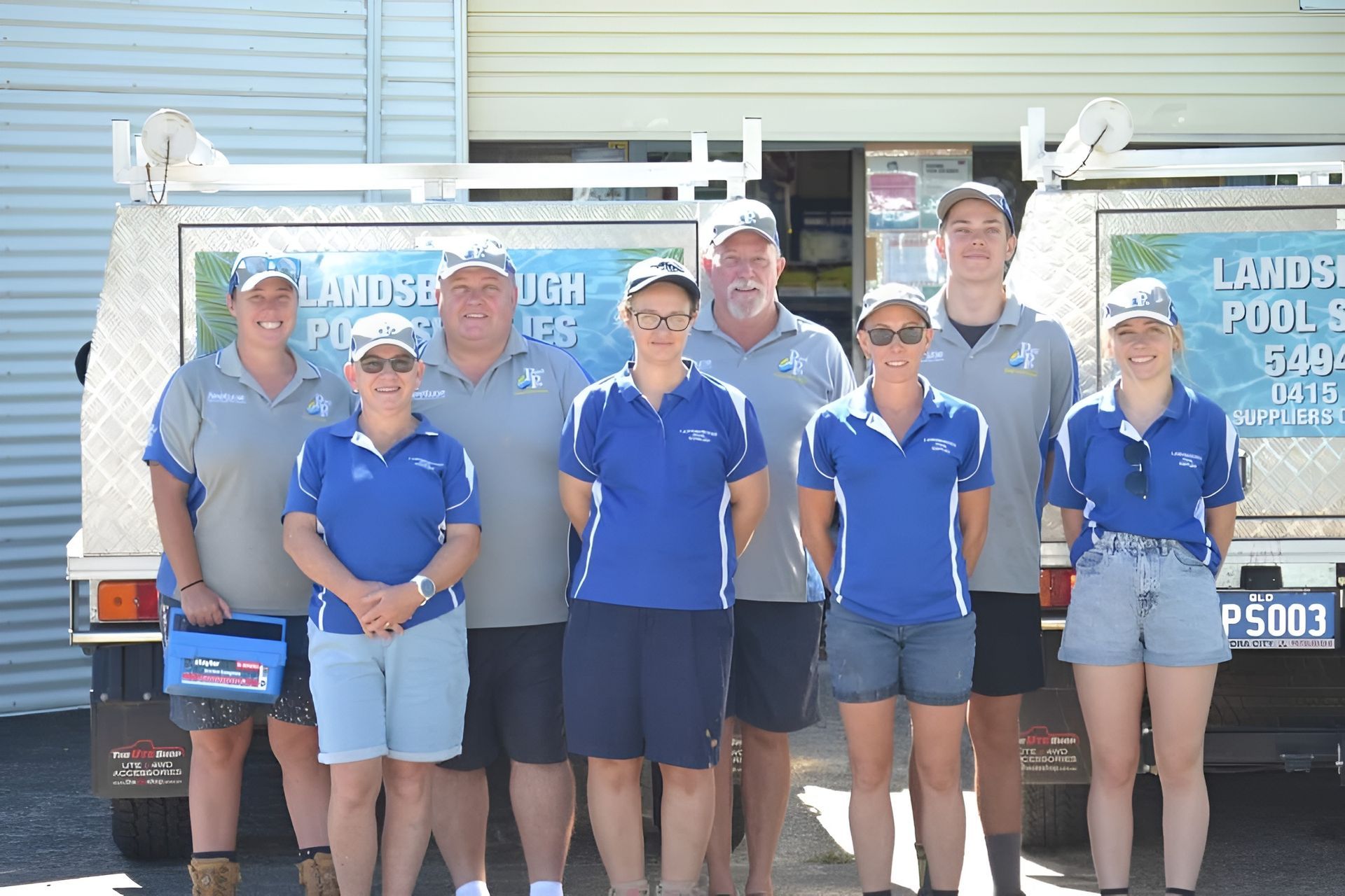 Group of People in Blue Shirts Stand — Landsborough Pool Supplies & Service in Landsborough, QLD