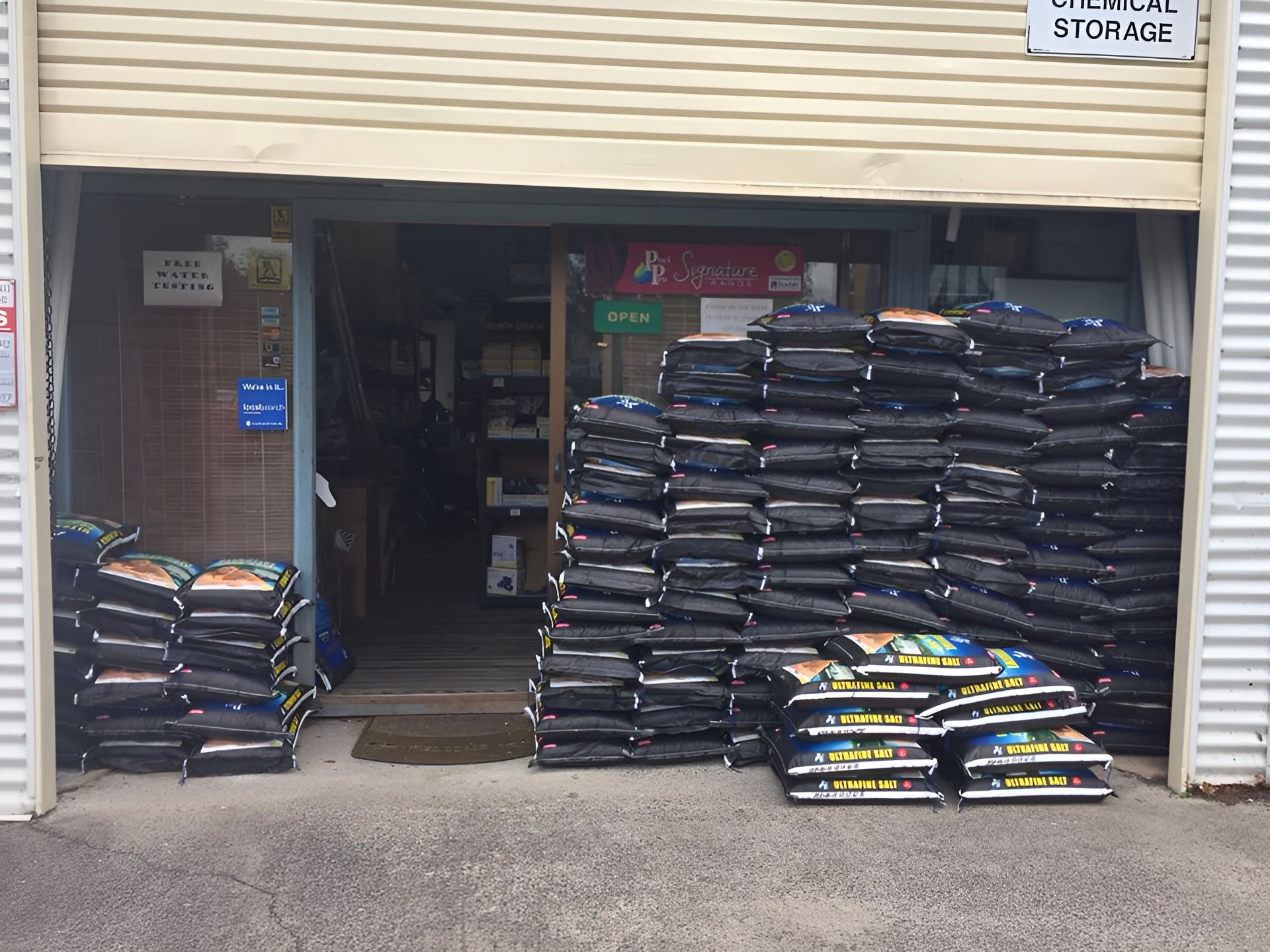 Exterior of a Store With Many Stacked Black Bags — Landsborough Pool Supplies & Service in Landsborough, QLD
