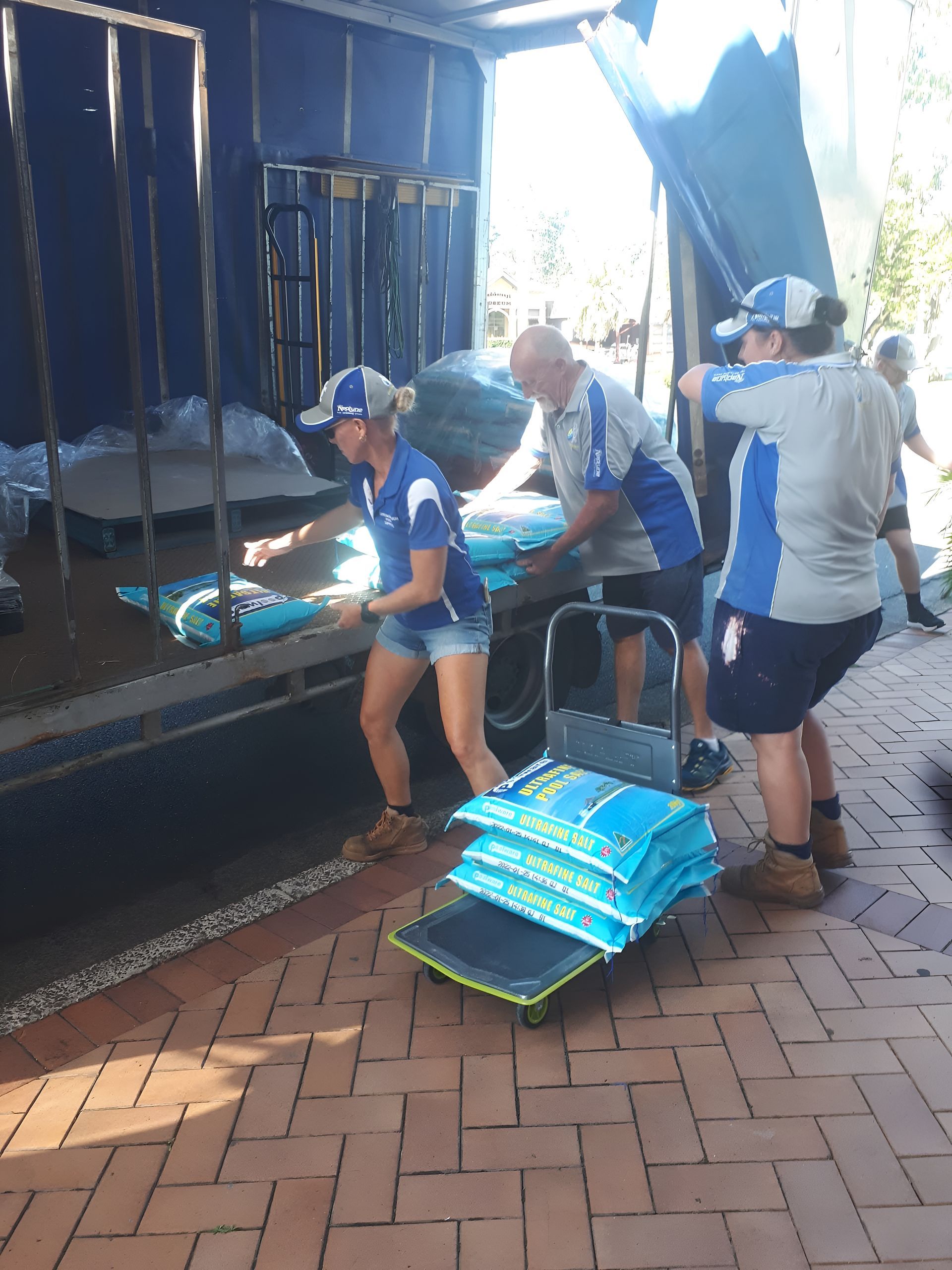 People Unloading Bags From a Truck — Landsborough Pool Supplies & Service in Landsborough, QLD
