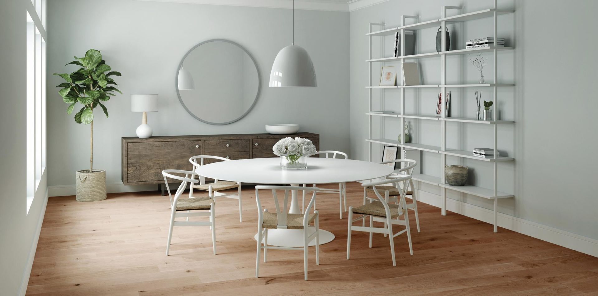 A dining room with a round table and chairs and a bookshelf.