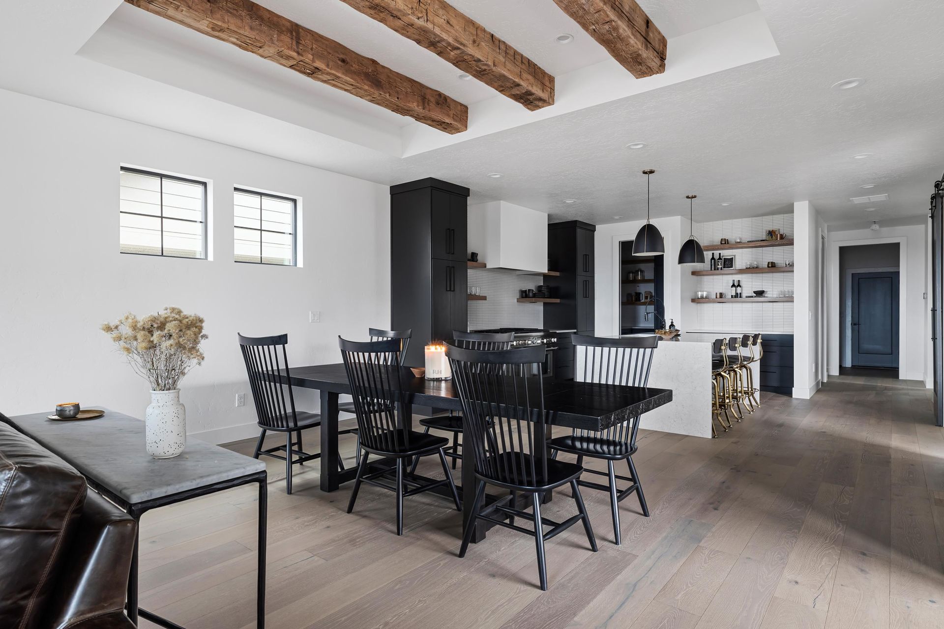 A living room with a table and chairs in it