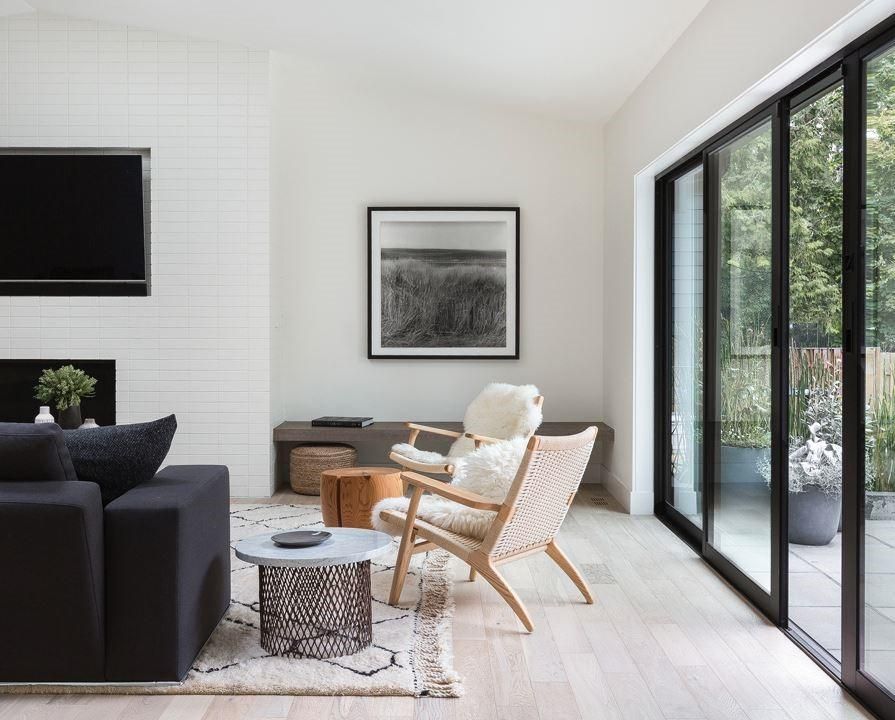 A living room with a couch , chairs , table and television.
