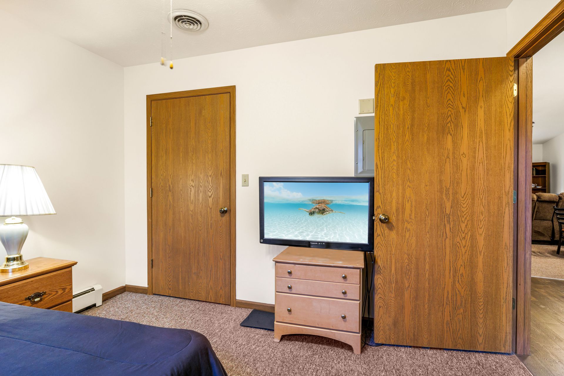 A bedroom with a bed and a television on a stand