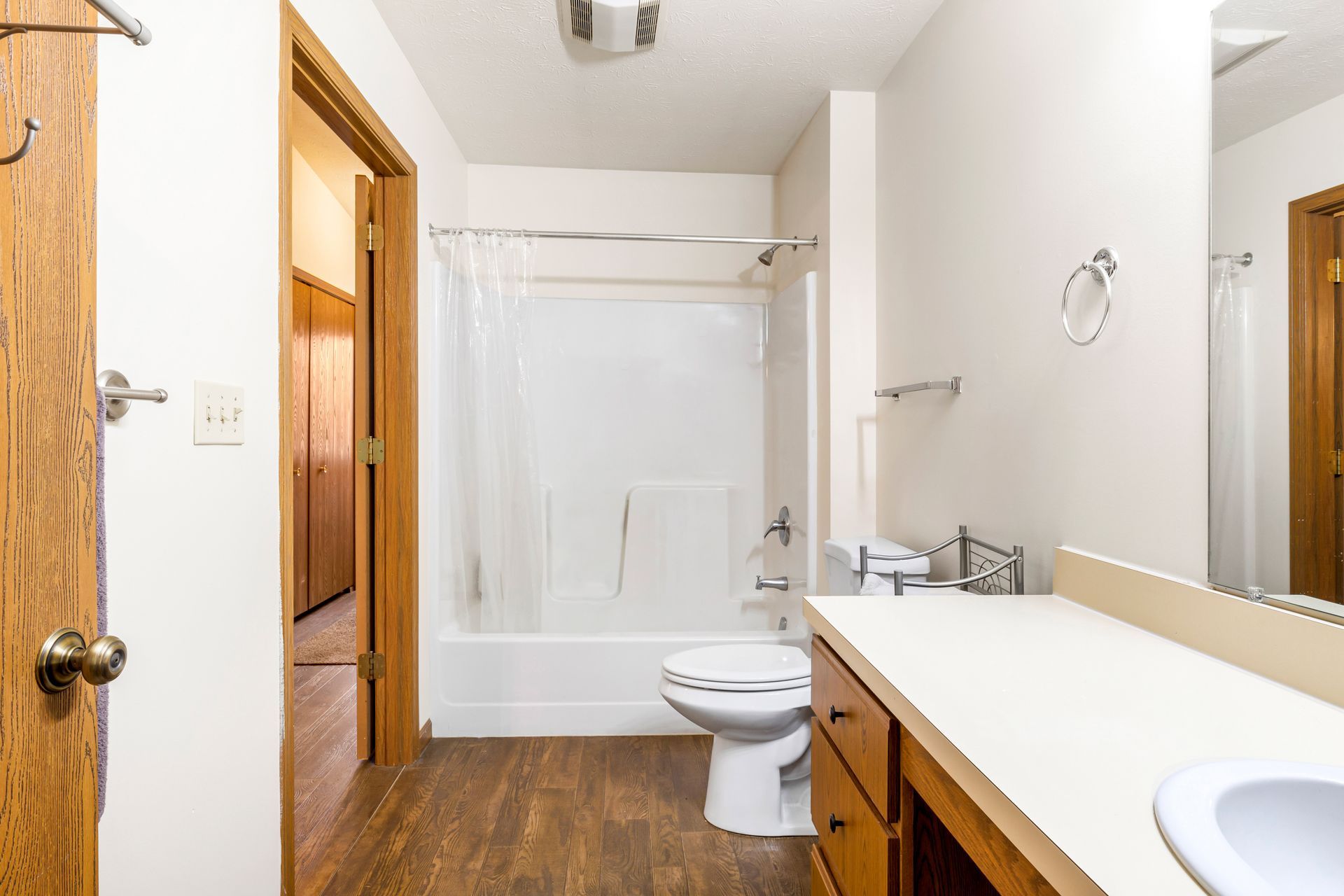 A bathroom with a toilet , sink , and shower.
