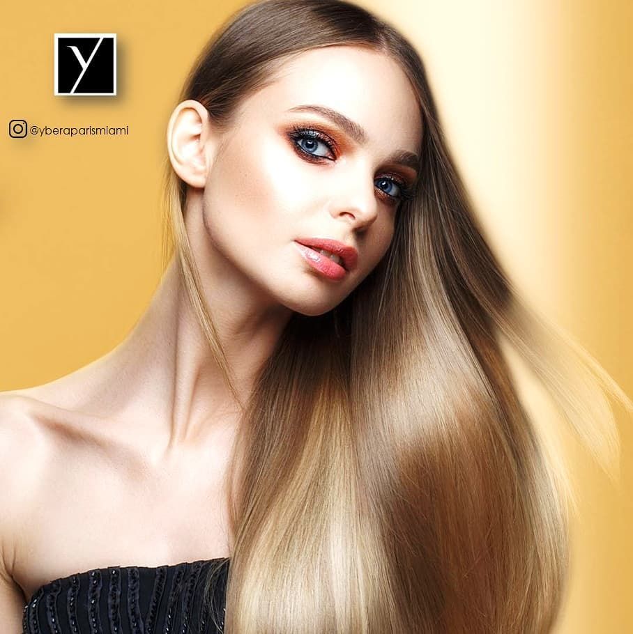 A woman with long hair is wearing a black strapless top