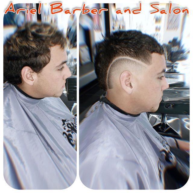 A man is getting his hair cut at the ariel barber and salon