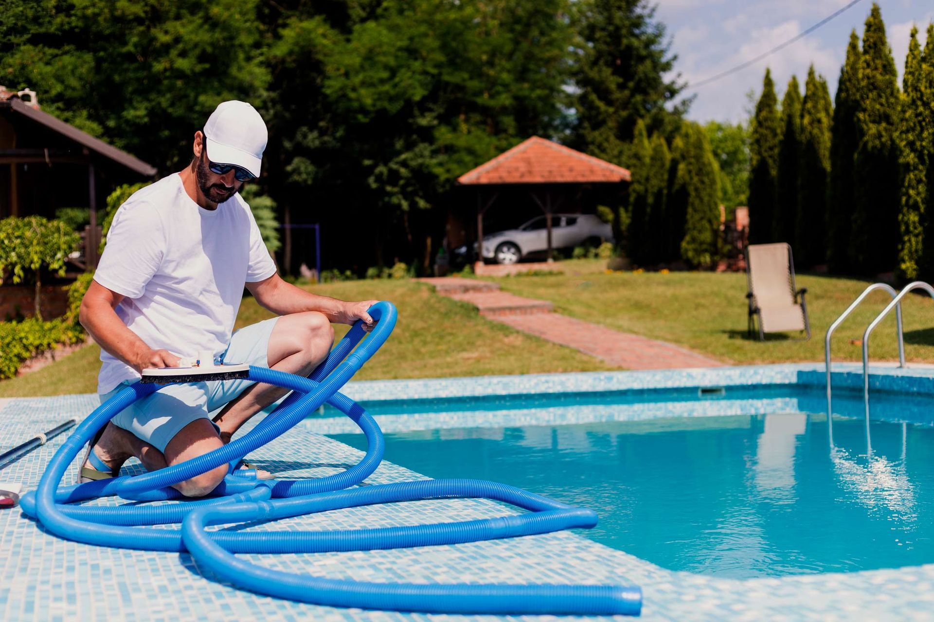 Mature Man In Flip Flops Cleaning The Swimming Pool — Green Valley, AZ — Green Valley Pools & Spa