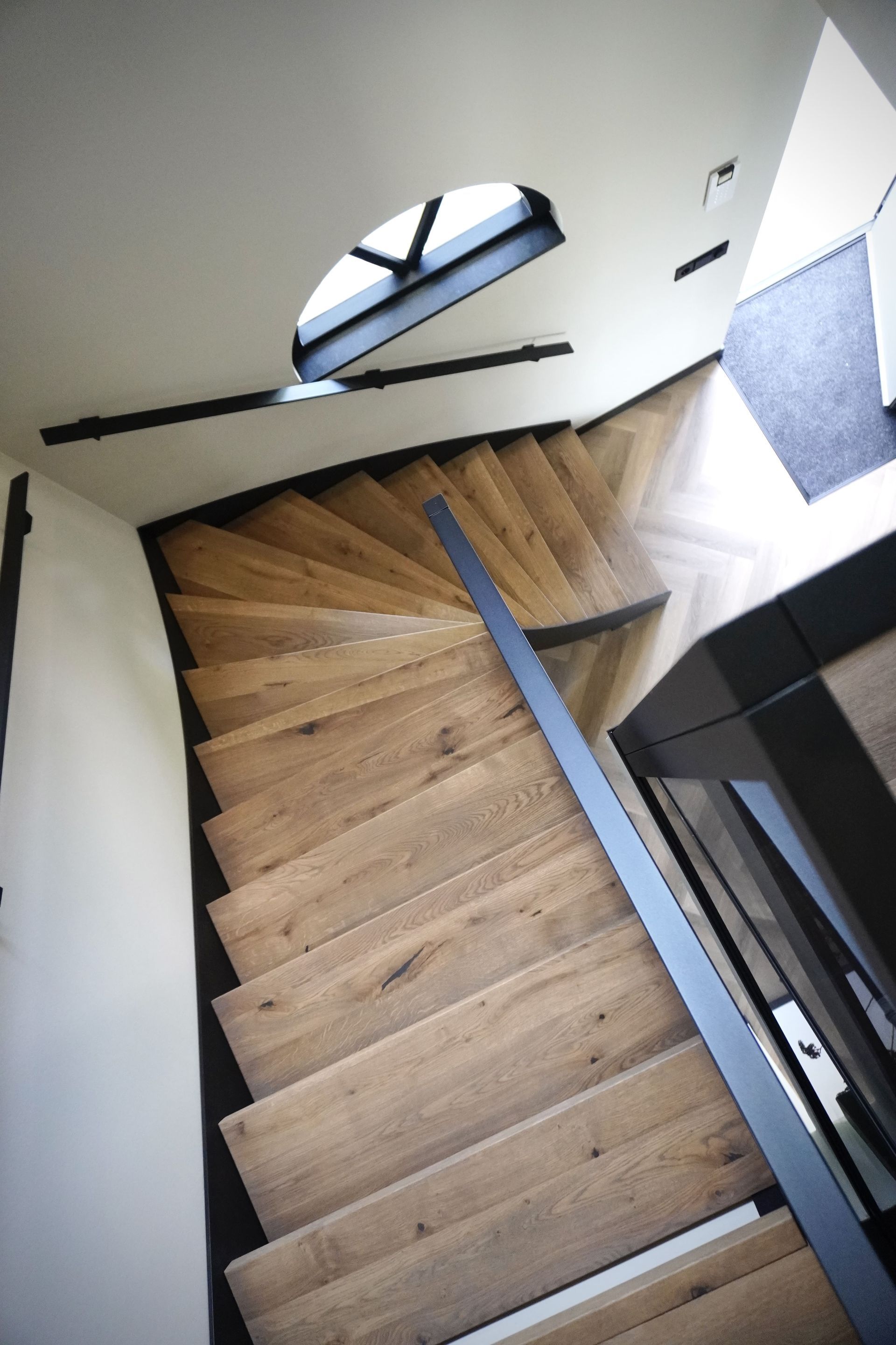 Warme eiken treden in combinatie met stoere stalen trapbomen