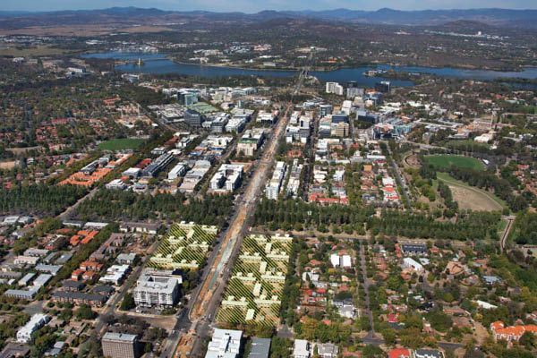 An aerial view of a city with mountains in the background.