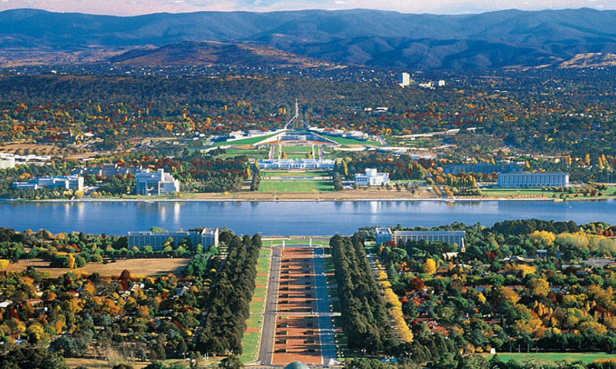 An aerial view of a city with mountains in the background