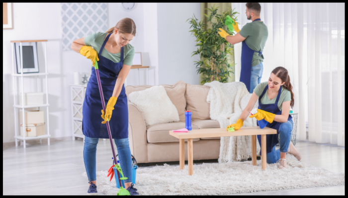 A person is cleaning a wall with a spray bottle and a cloth.