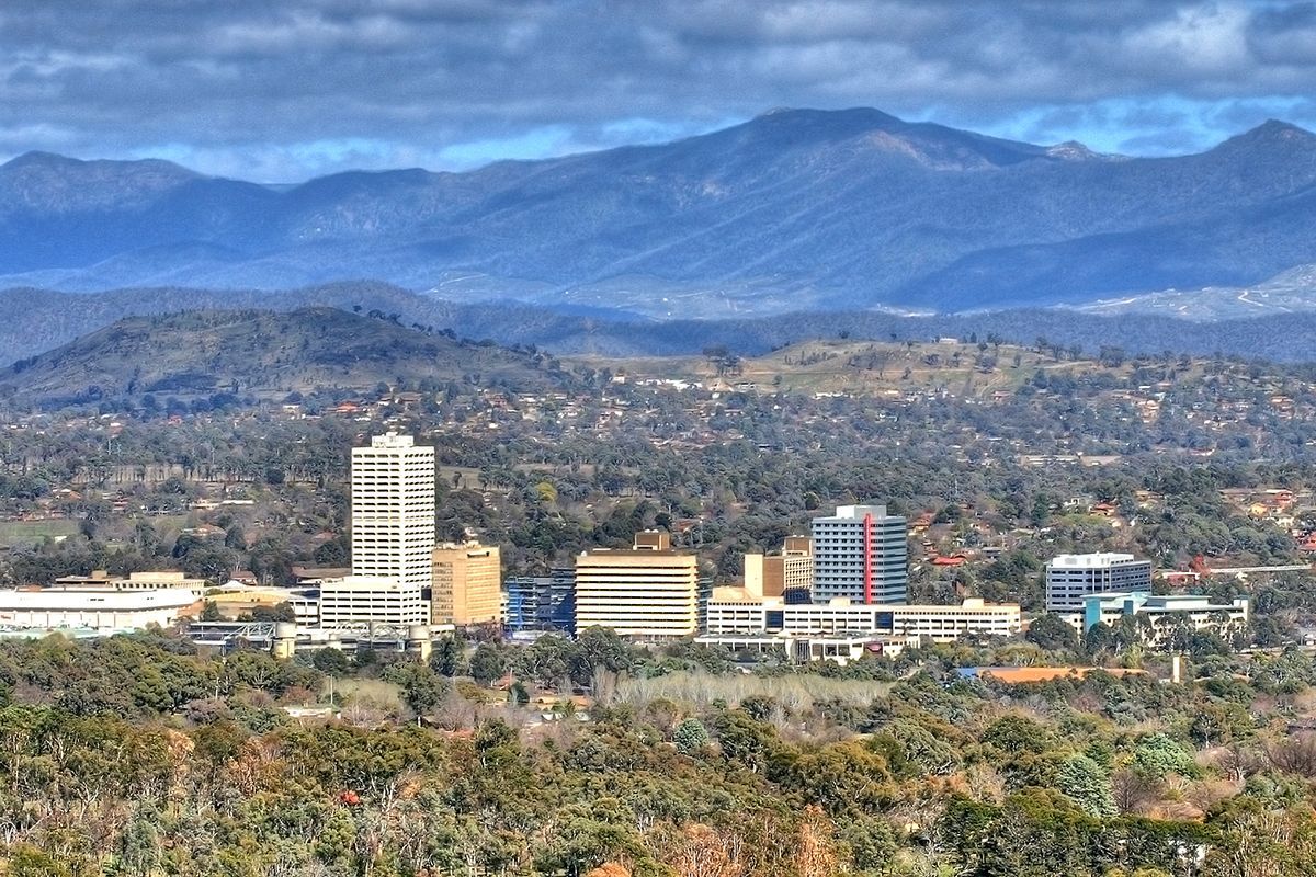 An aerial view of a city with mountains in the background.