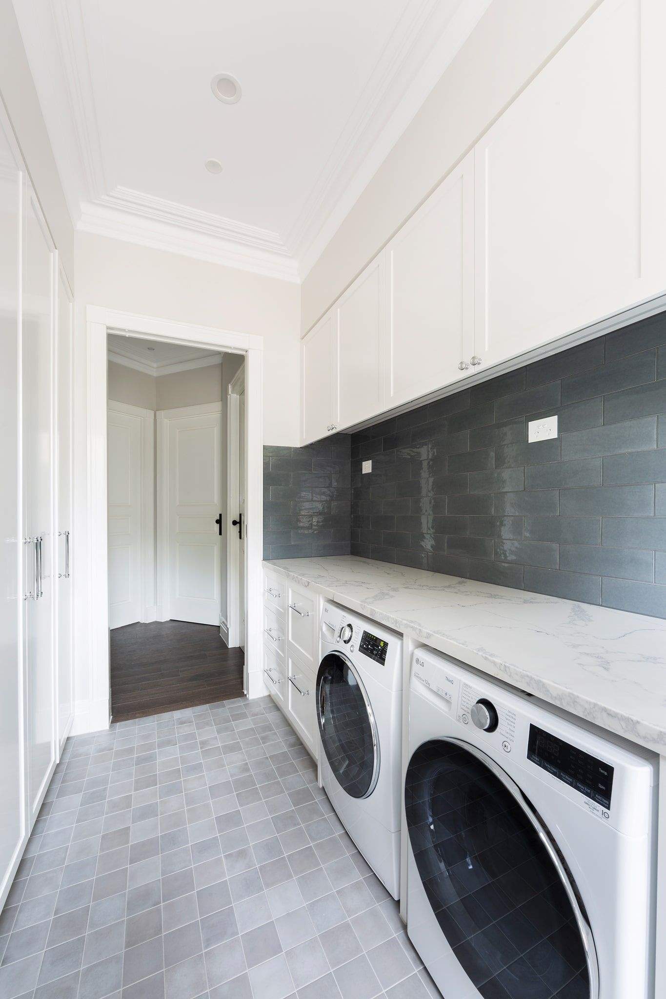 A laundry room with a washer and dryer in it.