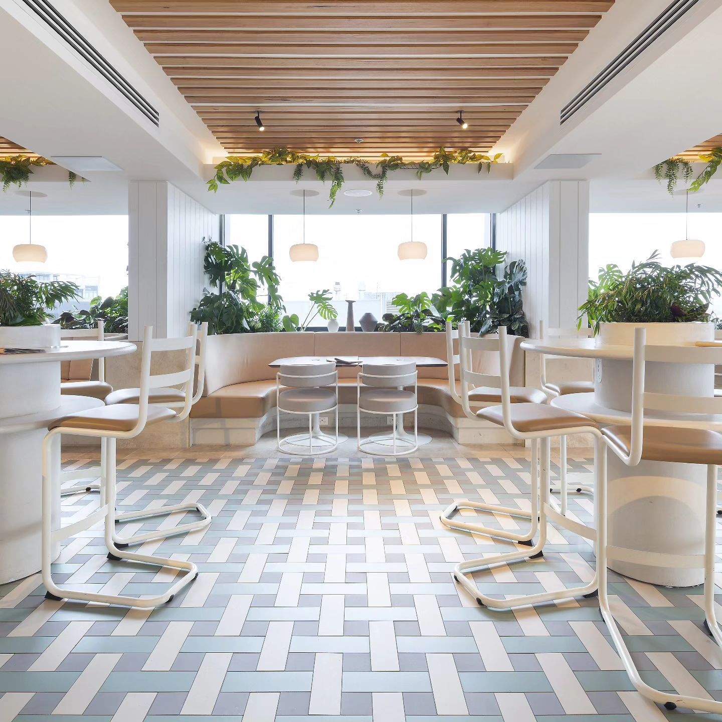 A restaurant with tables and chairs and a checkered floor