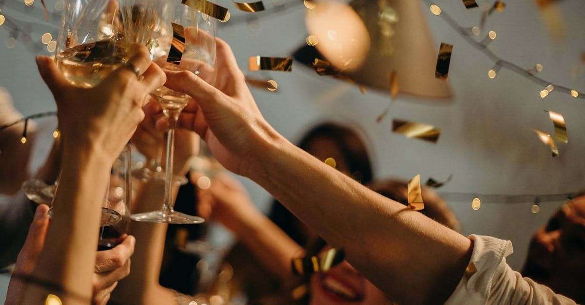 A group of people are toasting with champagne glasses at a party.