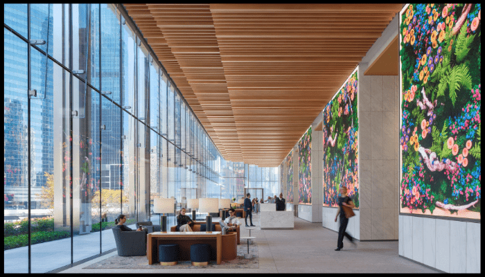 Spacious and clean shared lobby in a strata building with residents seated and walking, reflecting tenant satisfaction and proactive maintenance.