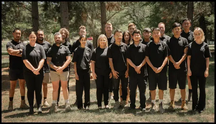 Professional cleaning team posing outdoors.