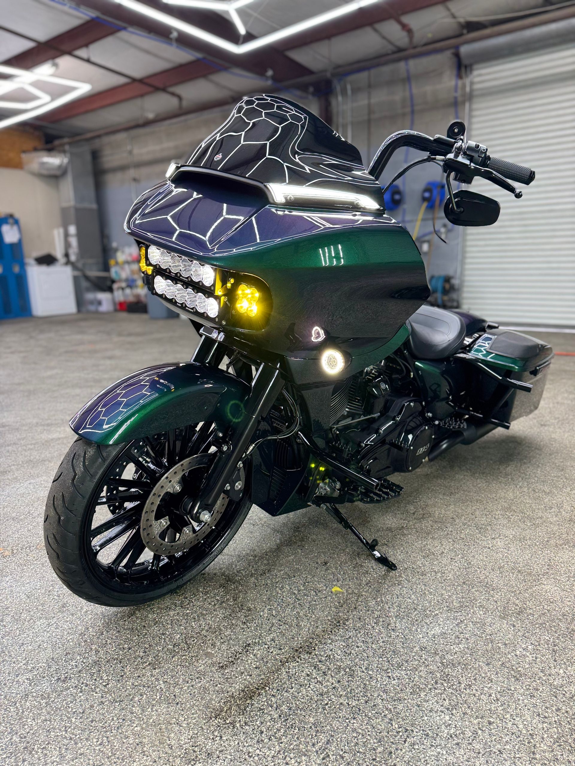 Custom green and black motorcycle with unique lighting.