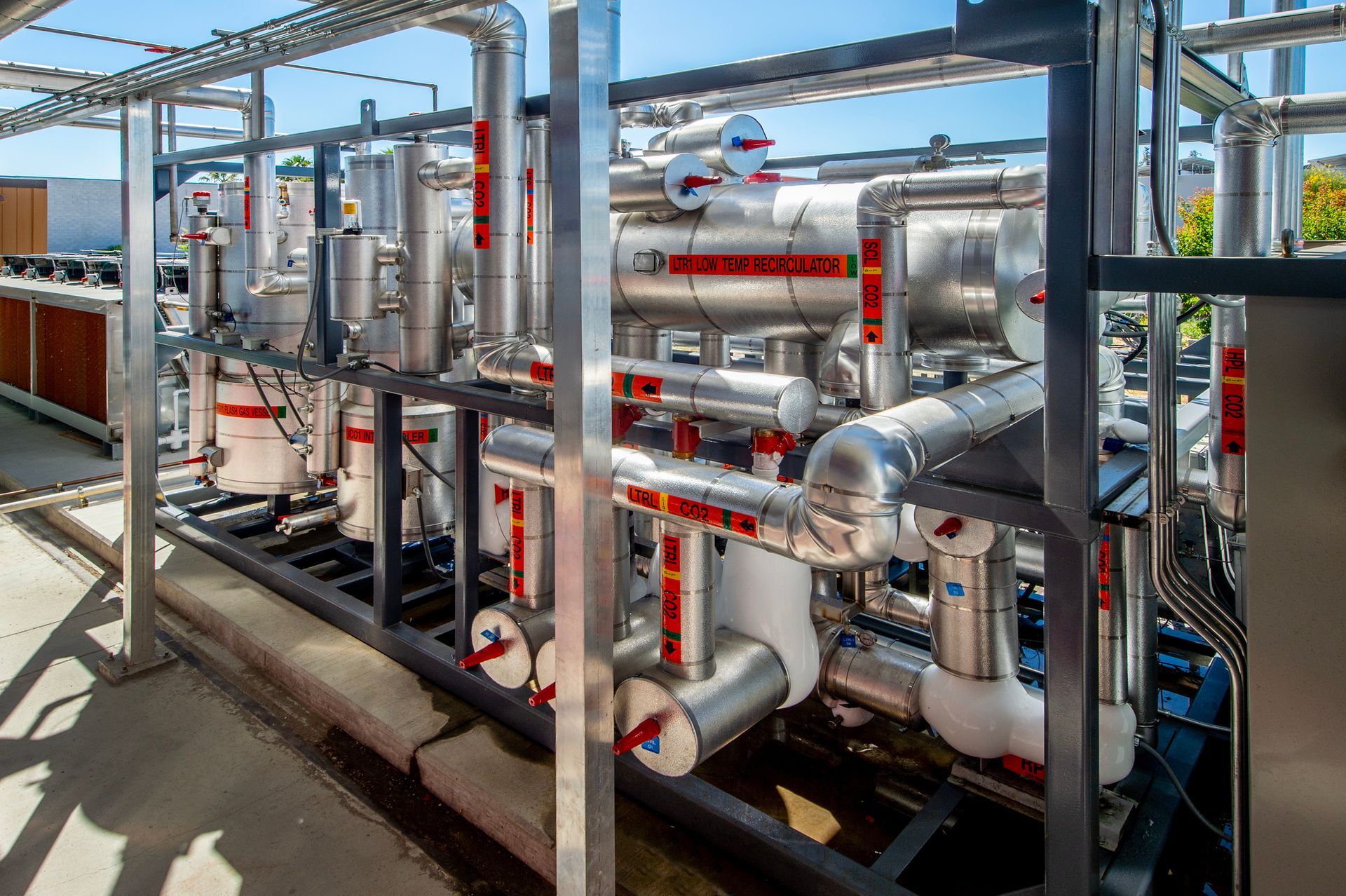 A large industrial area with a lot of pipes and buildings.