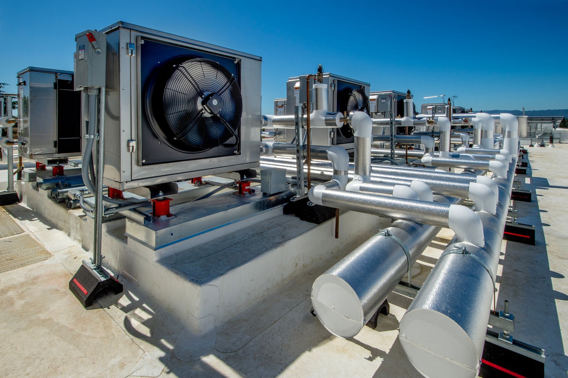 A blue building with a lot of pipes on it.
