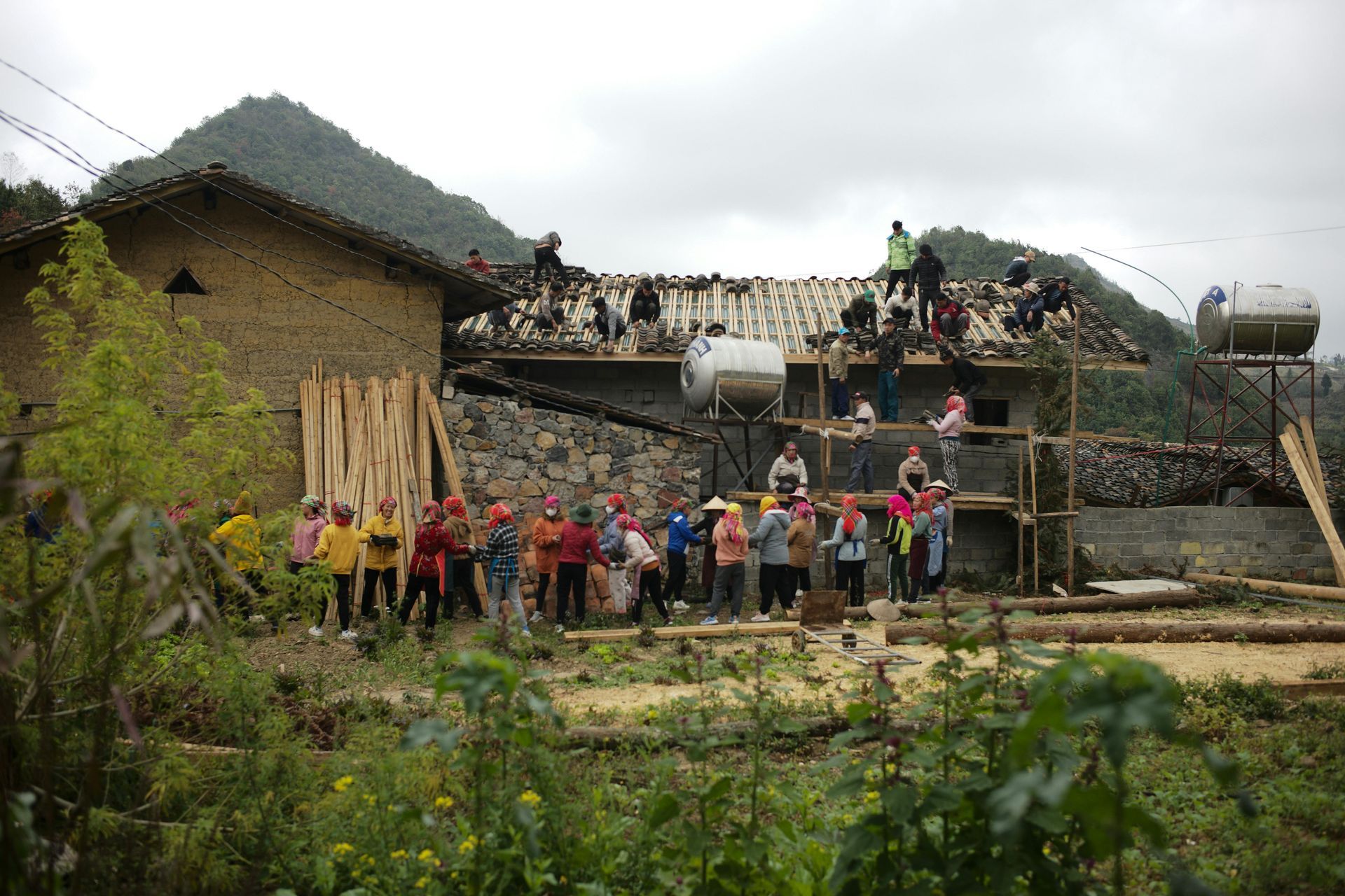 A group of people are standing in front of a building under construction.