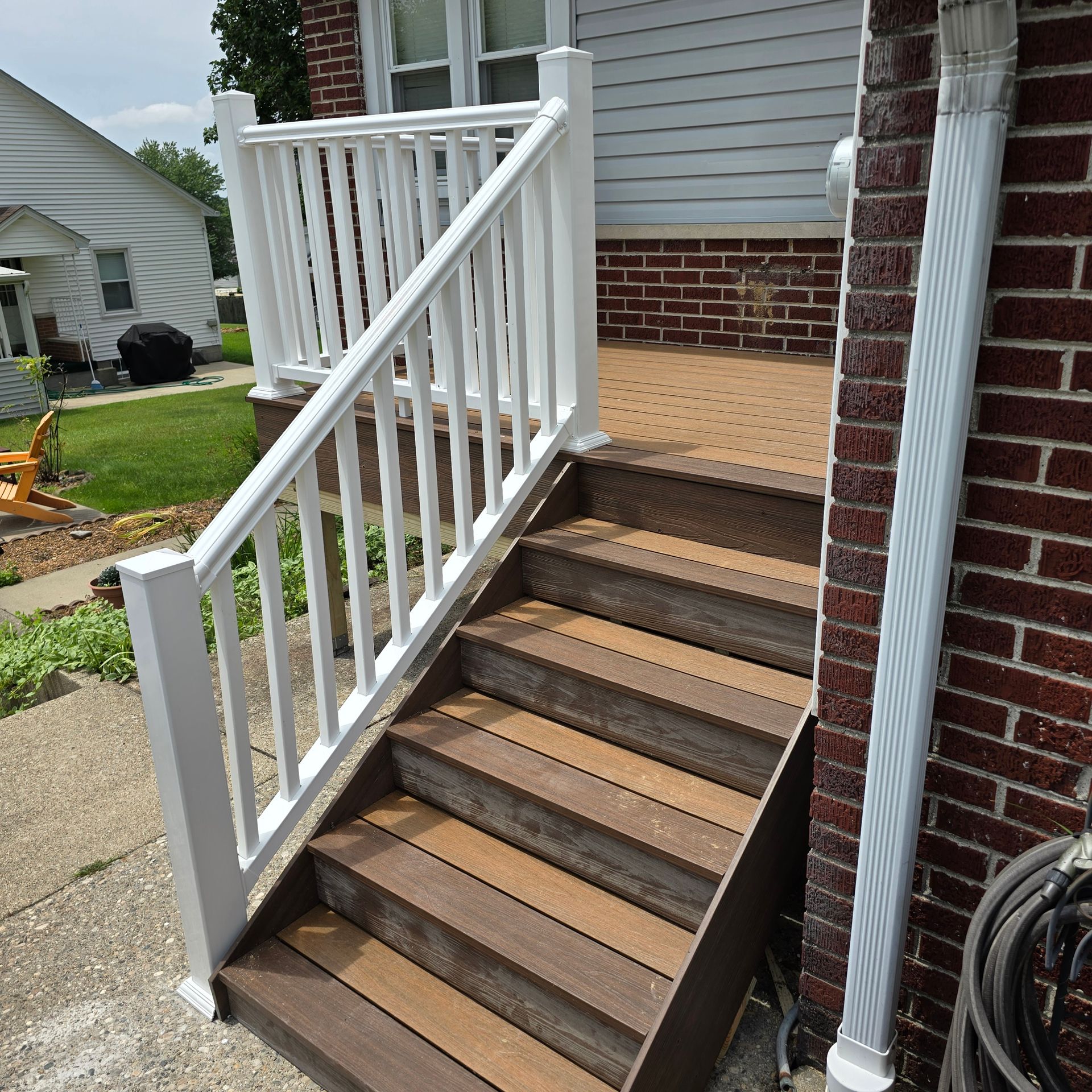 A set of wooden stairs with a white railing
