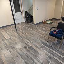 A room with a wooden floor and a chair in it.