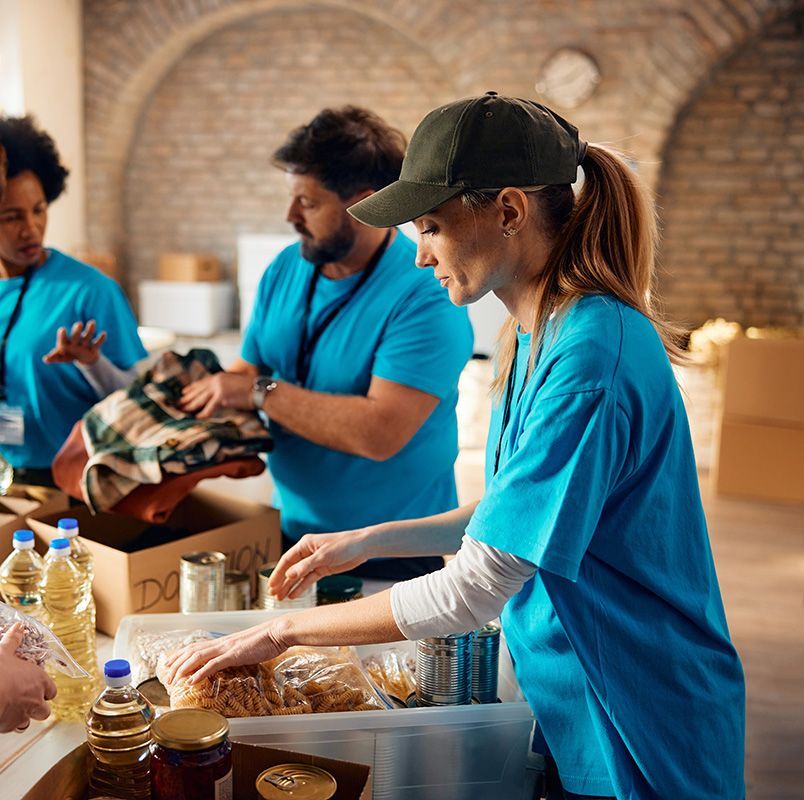 A group of people in blue shirts doing community service