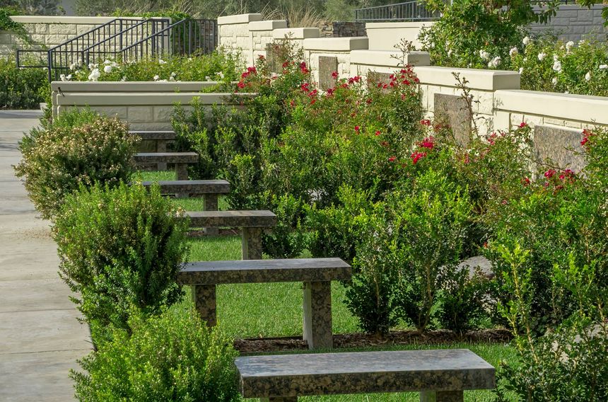 A row of stone benches are lined up in Hillside Memorial Park and Motuary