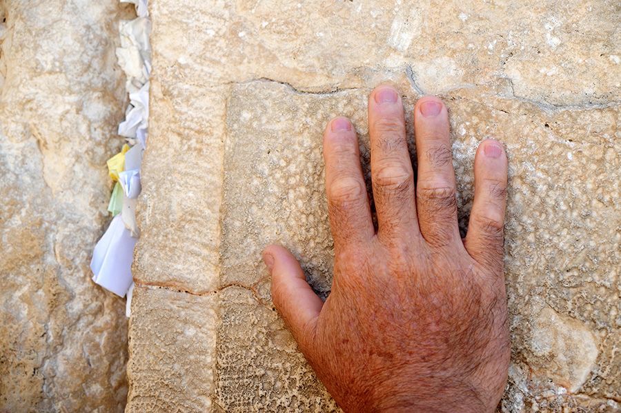 Hand on wall in Jerusalem