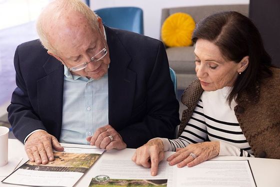 Senior couple looking over burial options at HIllside