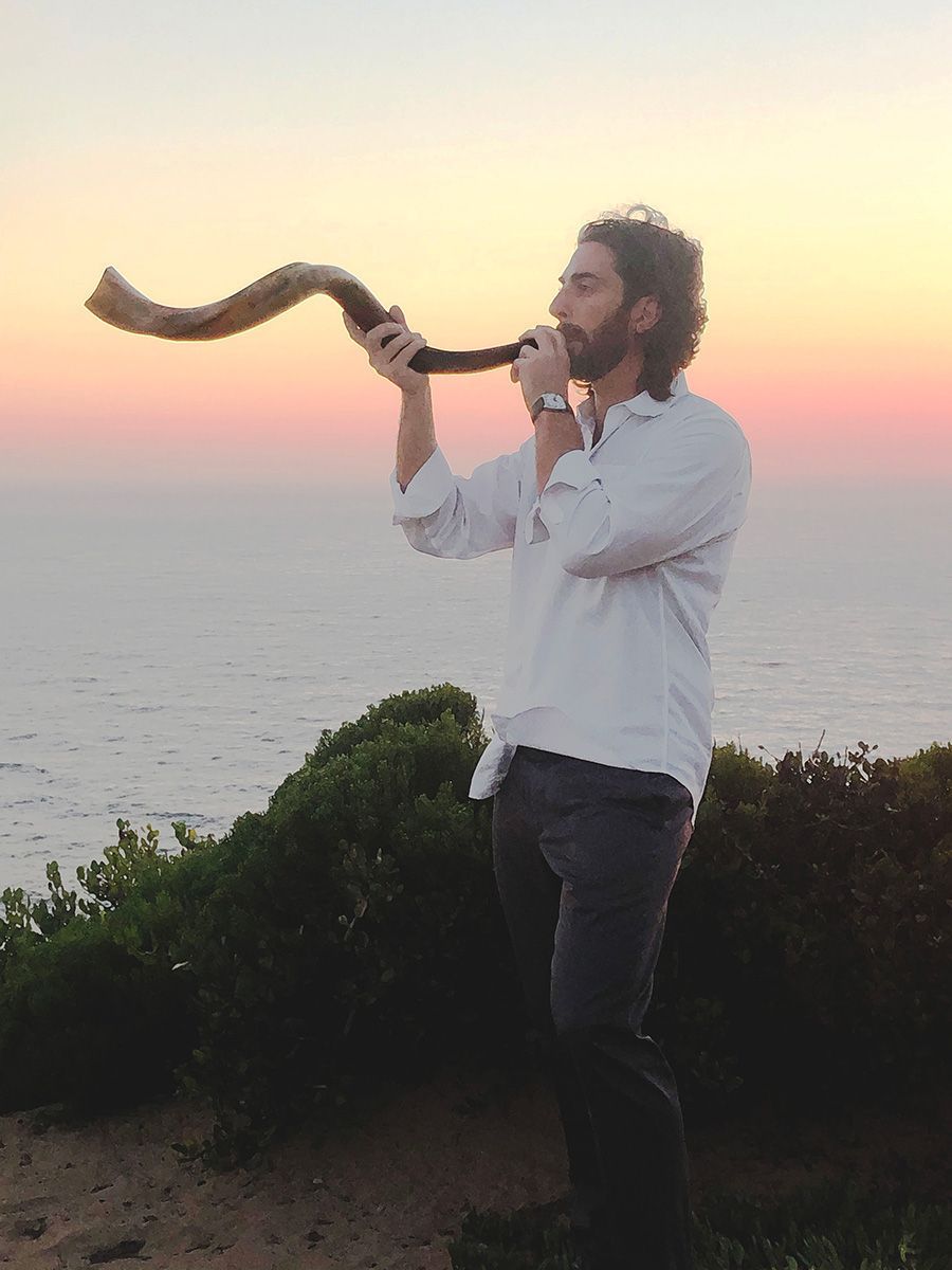 A man blowing a horn shofar