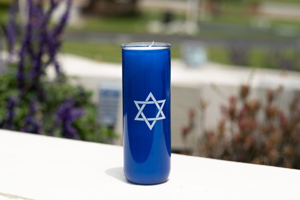 A blue can with a star of david on it is sitting on a table.