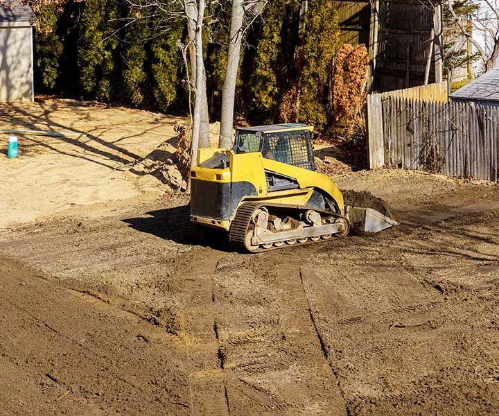 Bulldozer moving, leveling ground at construction site 
