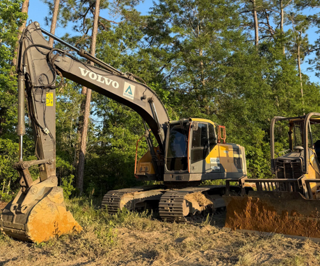 excavator in construction site on sunset sky background 
