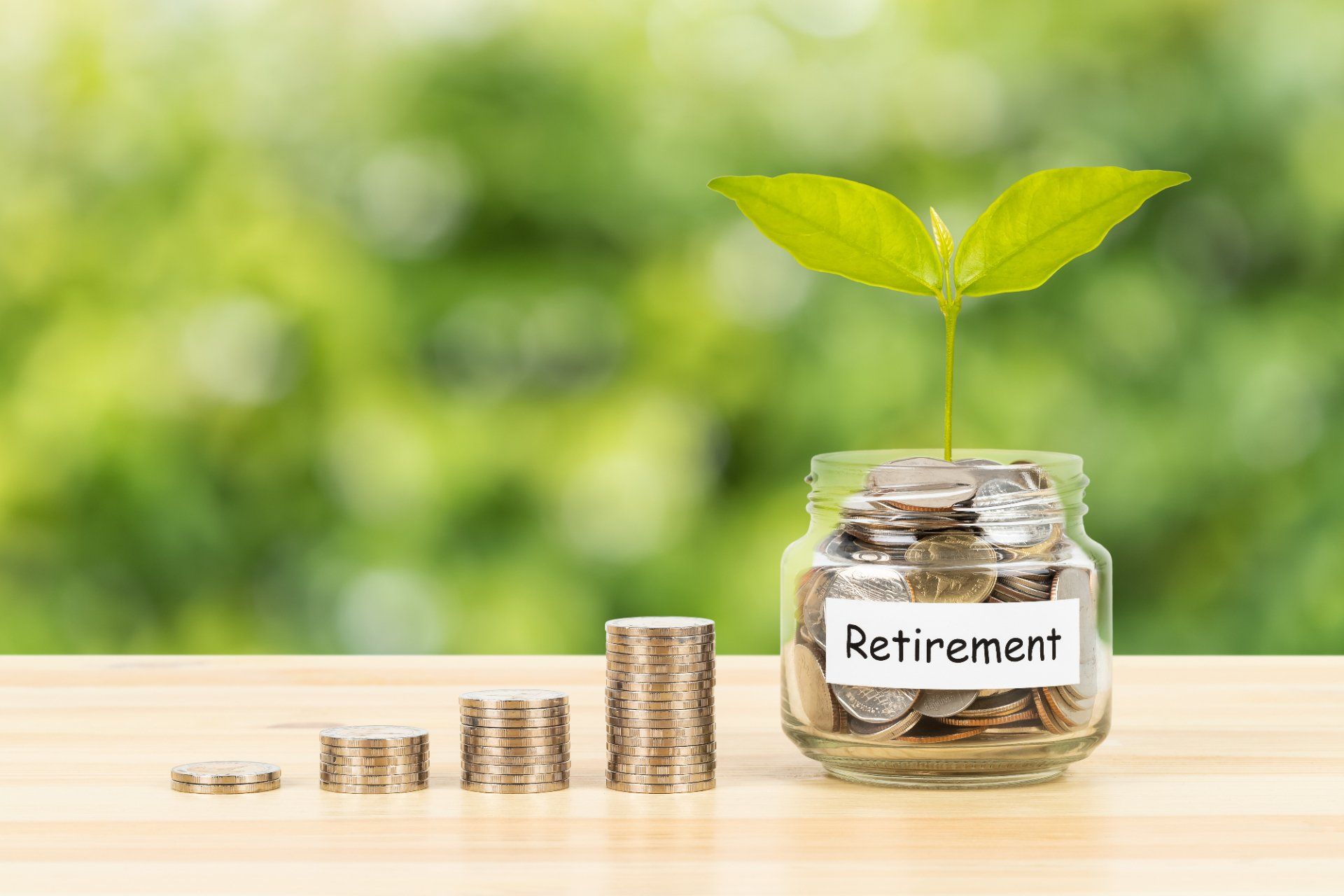 A jar filled with coins and a plant growing out of it.