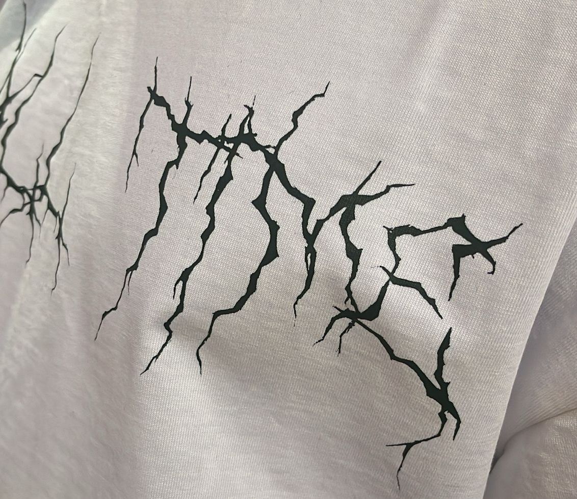 The back of a white shirt has a picture of jesus on it