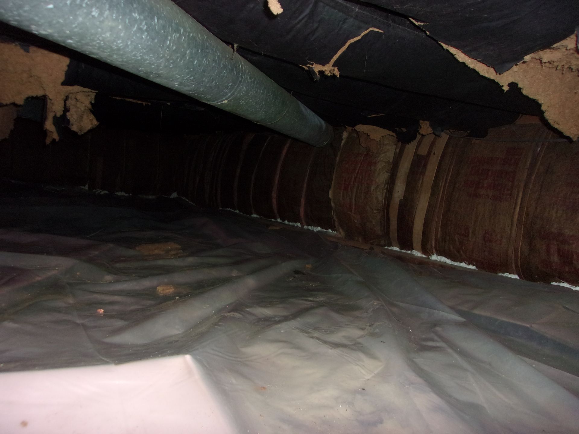 Before image of the crawlspace underneath a mobile home