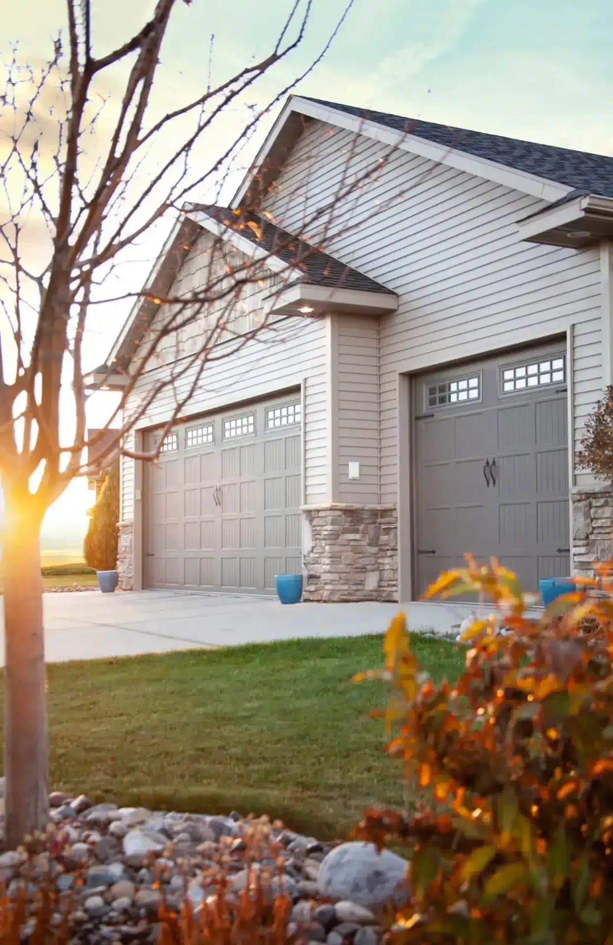 Beige Carriage Style Garage Doors, showing a single and double bay entrance