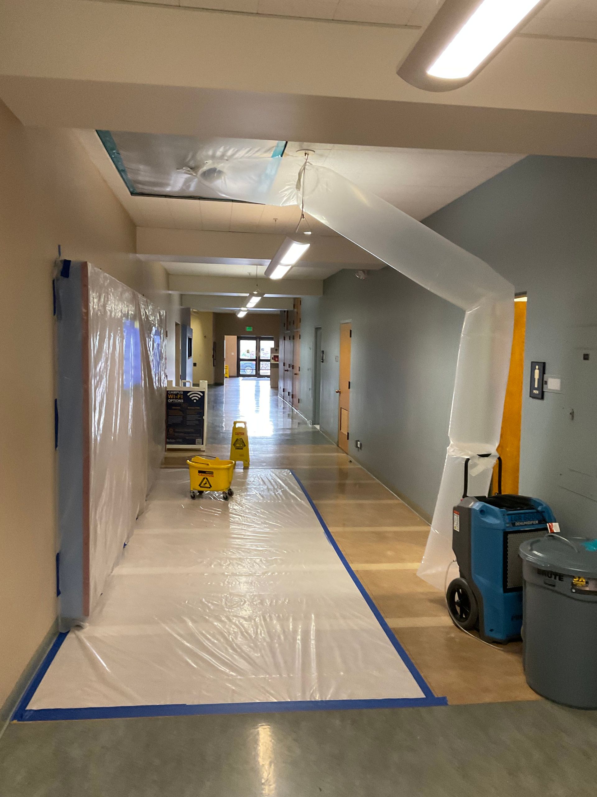 A hallway with a white tarp on the floor