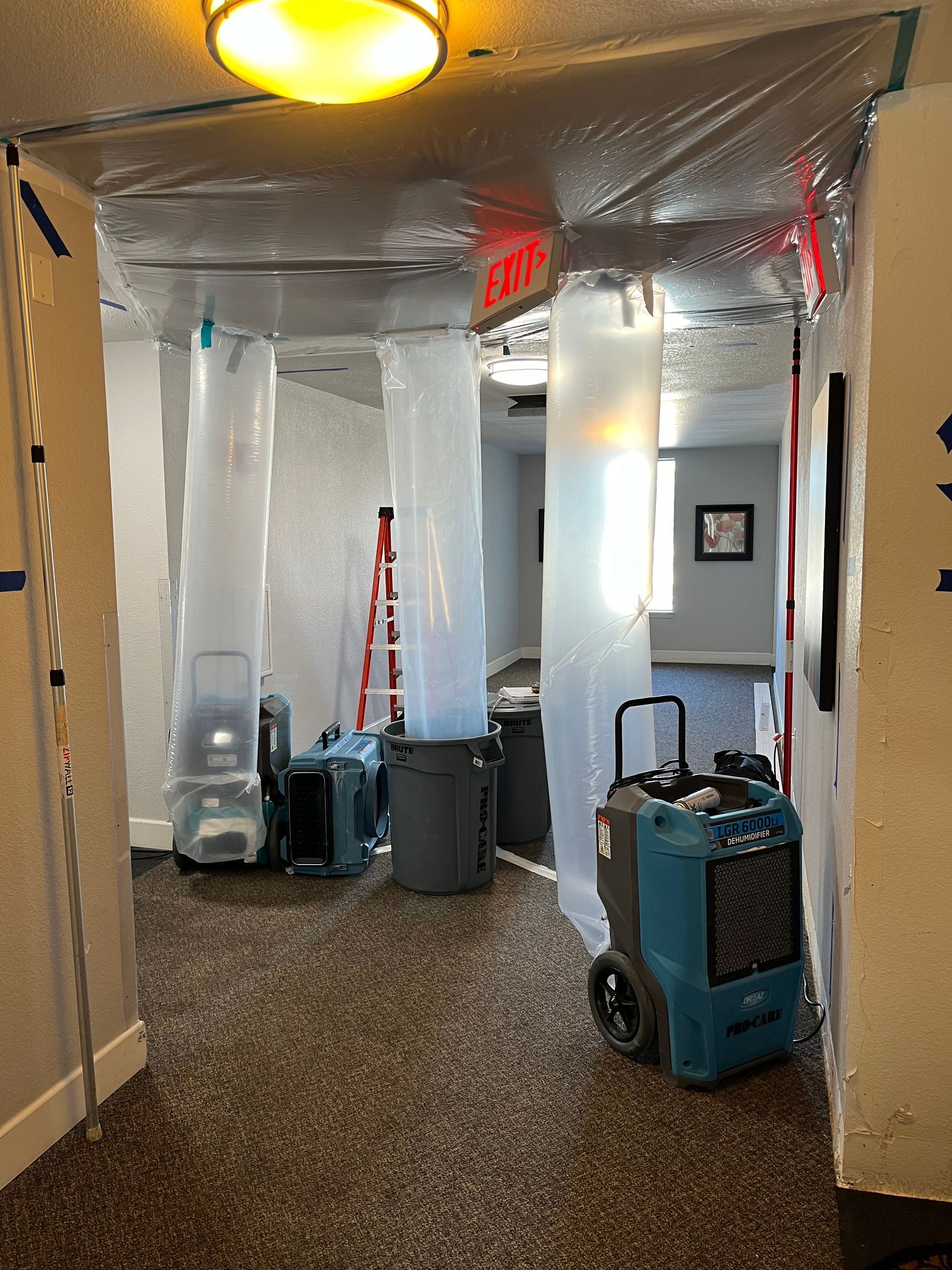 A hallway with a lot of plastic covering the walls and ceiling.