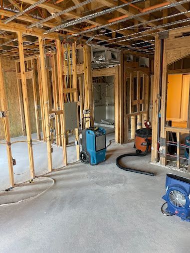 A room with a lot of wooden beams and a vacuum cleaner in it.