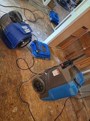 A couple of vacuum cleaners sitting on top of a wooden floor.