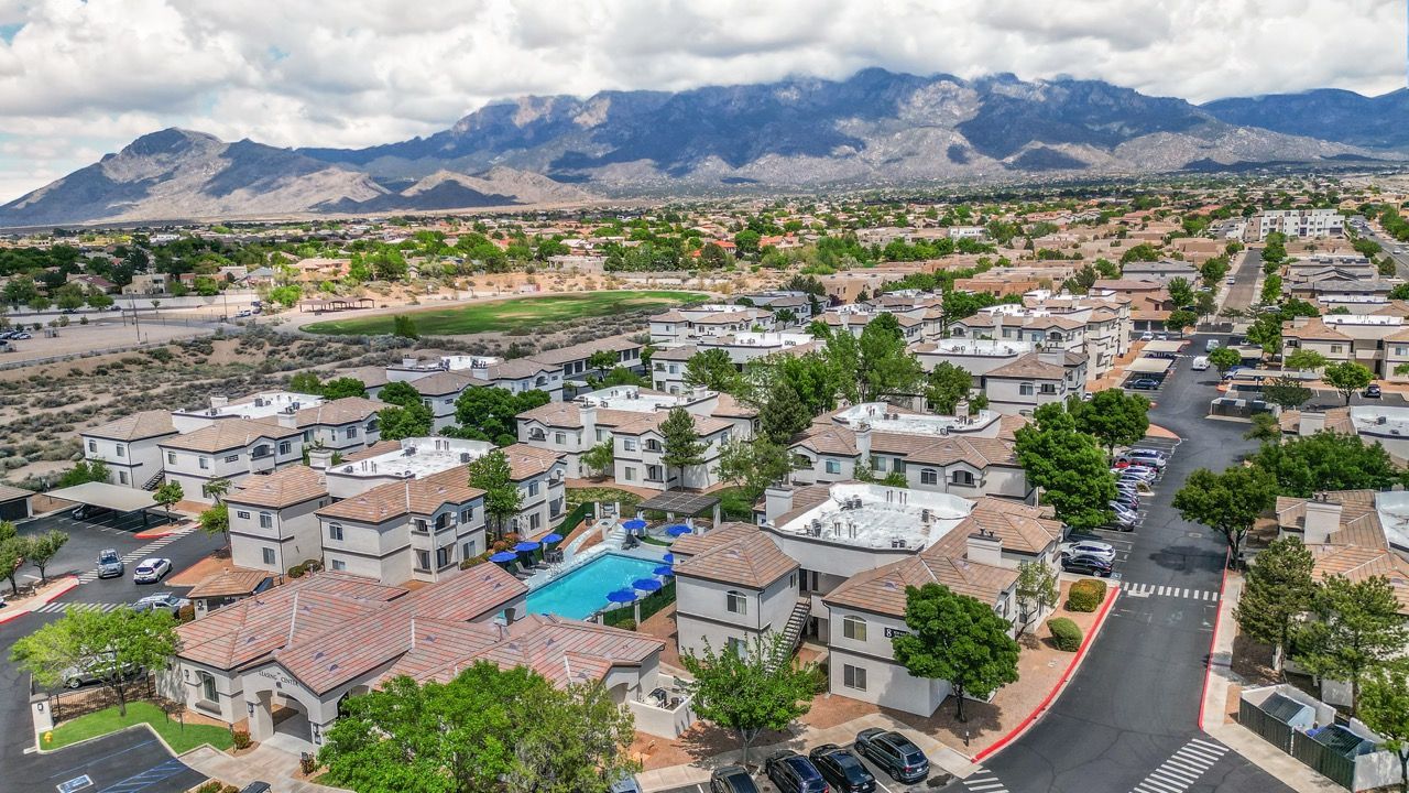 Aerial view of a multi-building apartment community with a central pool and surrounding streets at Broadstone Heights in Albuquerque, NM.