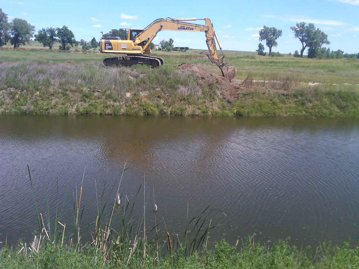 Excavator digging and river - Excavation in Lamar, CO