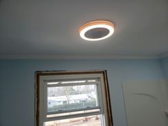Ceiling light and window in a room with light blue walls and a white ceiling.